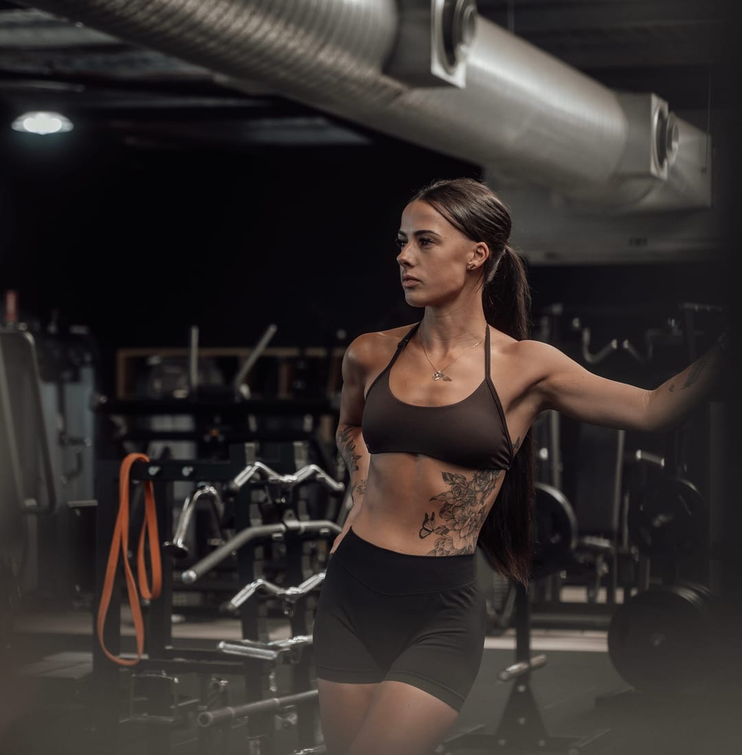 A woman in her 40s training with focus at Doherty's Gym in Perth.