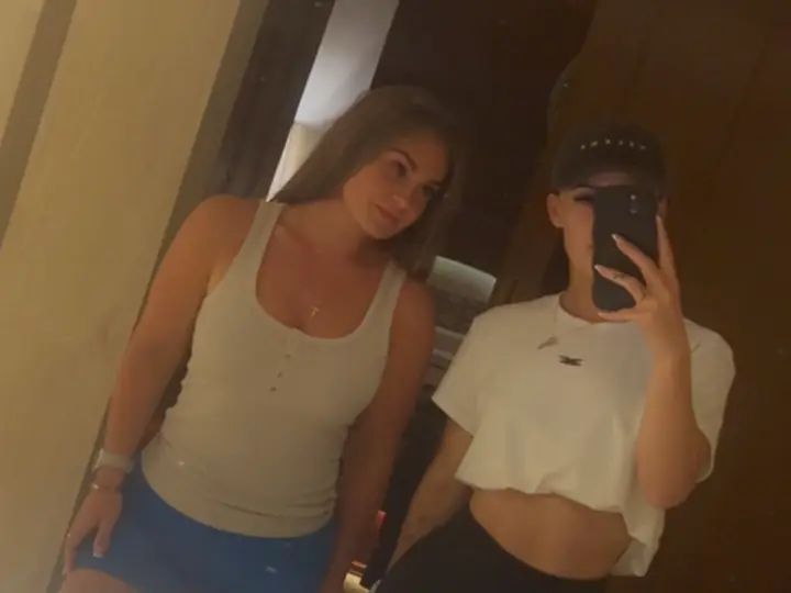 Kara and Sam taking a mirror selfie together.